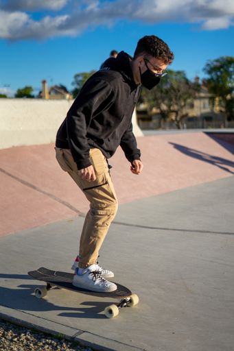 A vertical shot of a man skating a