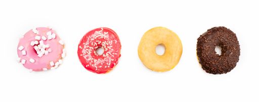 A closeup shot of four delicious donuts on a white background