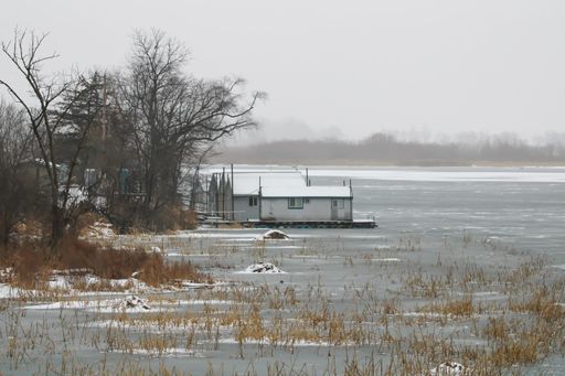 A beautiful shot of house boats moored on the pier of the frozen Mississippi River