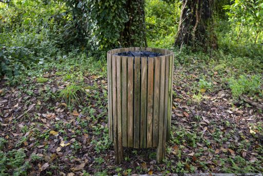 A closeup shot of a wooden trash bin in a park