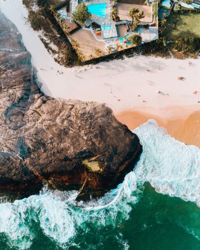 This beautiful drone shot from a bird's eyes view of a beach in Itacoatiara, Niterói, Rio de Janeiro - Brazil.