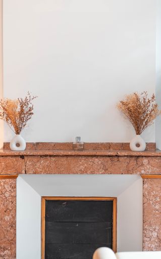A vertical of a living room chimney decor with marble