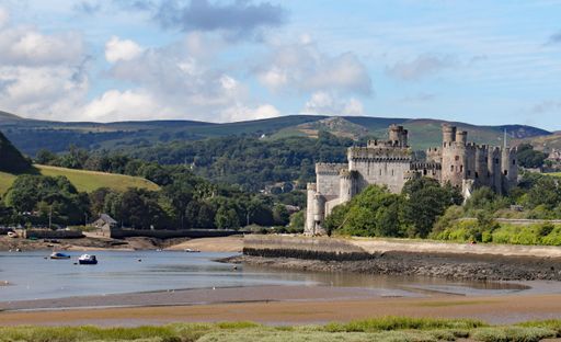 The Conwy Castle surrounded by hills and the River Conwy in Wales