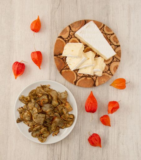 A top view of earth apple chips and sliced cheese on a table