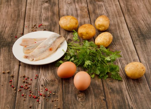 A closeup shot of vegetables, eggs, and fish on a table