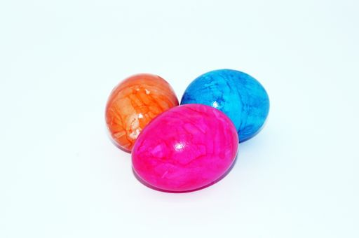 An isolated shot of colorful eggs on a white background- concept easter egg hunt