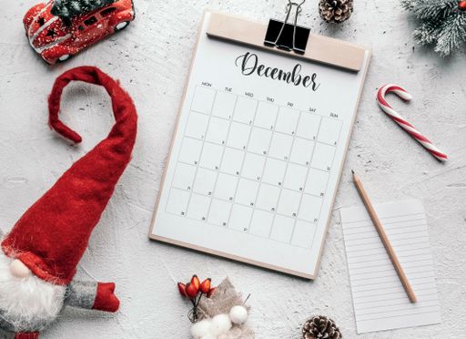 December calendar flat lay. Still life image of calendar and Christmas decorations on table.