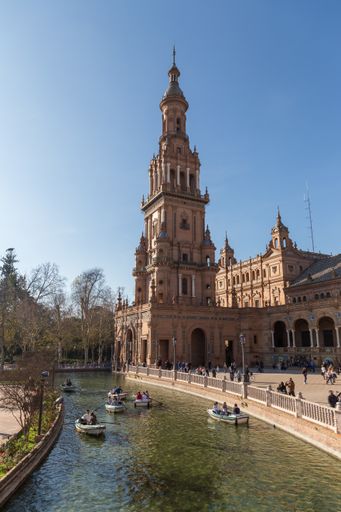 Vertical shot of tourists rowing boats in the Plaza de Espana in Seville. Attraction in Andalusia