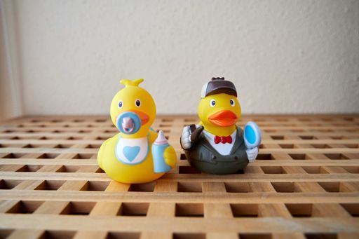 A closeup shot of funny rubber duck toys on a wooden surface