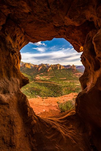 A beautiful view of Mitten Ridge in Sedona through a rocky window
