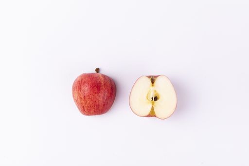 A fresh red cut apple isolated on a white background