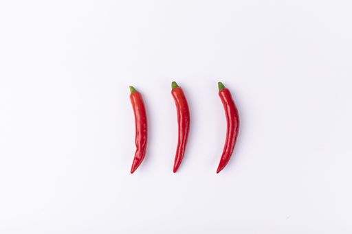 Three fresh chili peppers isolated on a white background