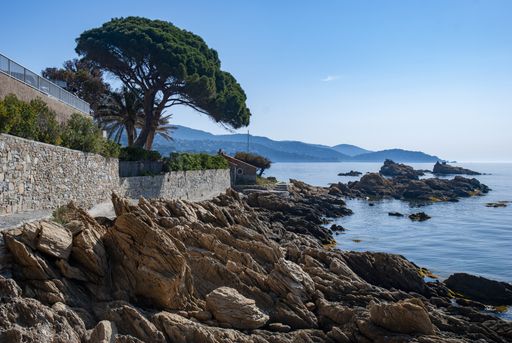 A landscape of the coast and the sea with the hills on the background in Le Lavandou in France
