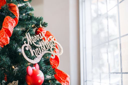 A Christmas tree decoration with bright balls and a Merry Christmas sign at home