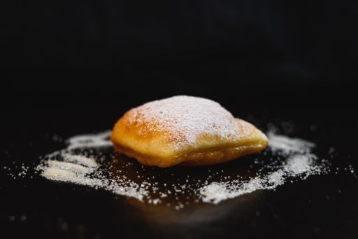 A  shot of homemade cakes with sweet powder on a black background
