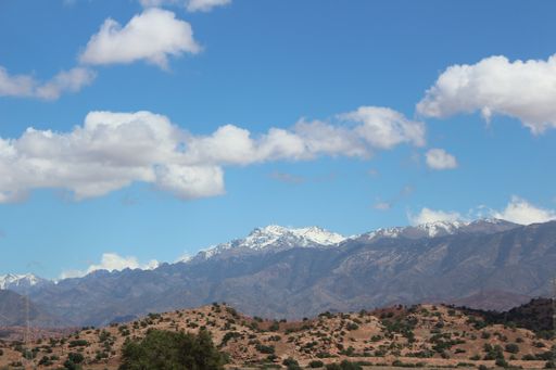 A beautiful landscape view with snow-capped mountain range and heavy cloudscape