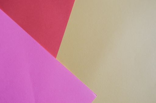 A geometric background made with colored papers - copy space
