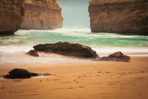 A lot of rock formations near the sea under the cloudy sky during daytime