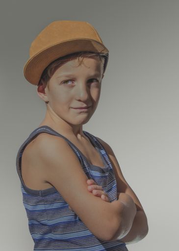 A portrait of a Caucasian boy posing and smiling