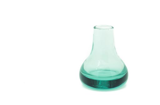 A closeup shot of a little green glass jar isolated on white background