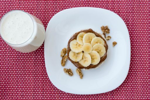 A top vie of dessert with bananas and chocolate cream on white plate