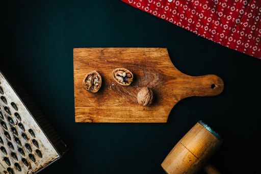 A top view of the walnut breaking process with a wooden mallet