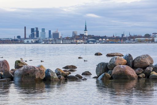 Scenic waterfront view on the Tallinn city with the new apartment buildings under construction and historic old town and skyscrapers on the background