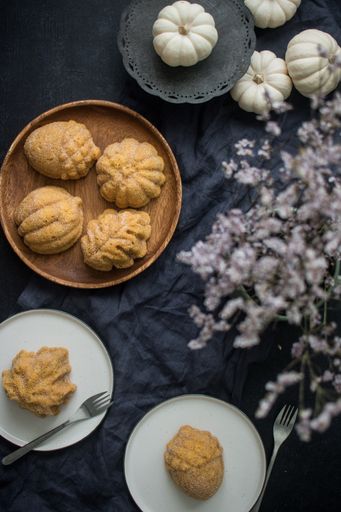 A top view of a dessert table with biscuits in the shape of leave and vegetables with lavender