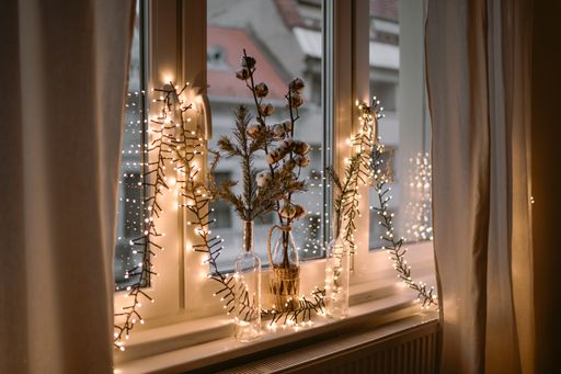 A selective focus shot of a windowsill with Christmas decorations