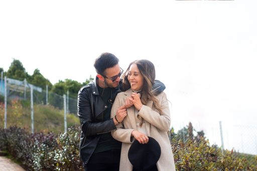 A selective focus shot of a cute couple looking at each other with love and smiling