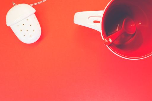 A top view of a teacup on a red background
