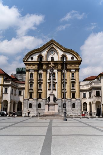 A vertical shot of a beautiful church of the Holy Trinity in Ljubljana, Slovenia under the cloudy sky