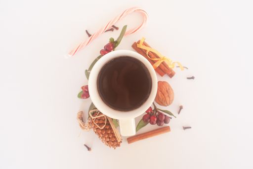 An overhead shot of a cup of coffee in a winter decoration set