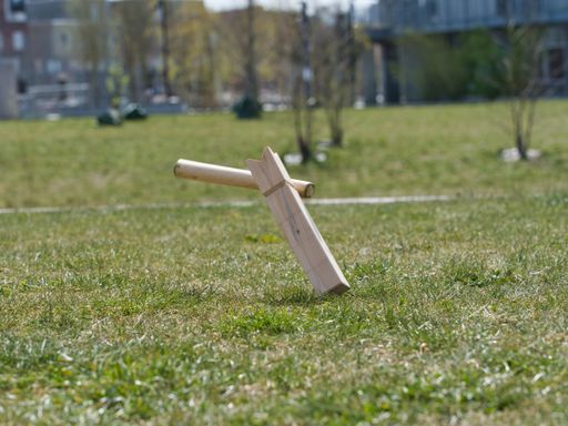 A selective focus shot of wooden pieces of traditional Viking chess on the grass-covered fiel