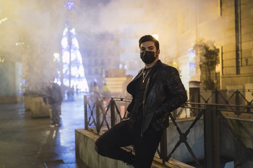 A shallow focus shot of a young European male in a black mask