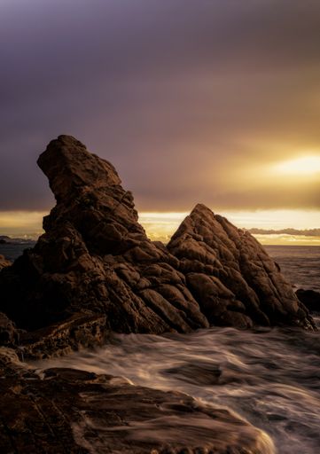 A beautiful vertical shot of the dramatic Sunrise in Cala Belladona - Calonge in Costa Brava