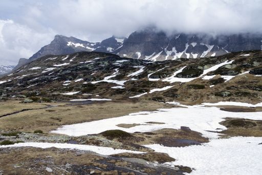 A beautiful winter landscape with snow-covered mountain under a cloudy sky