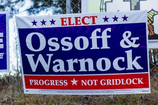 Lawrenceville, Georgia | United States - December 22 2020: Georgia Senate runoff election signs along the side of the road near a polling location