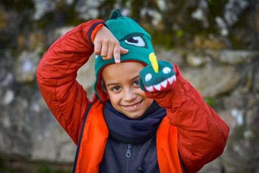 A shallow focus shot of a smiling boy playing outdoors in the park