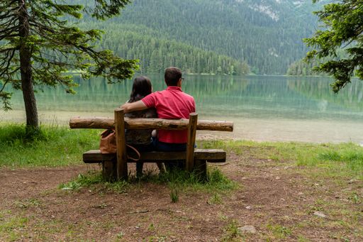 A coup sitting on a wooden bench in Durmitor National Park, Montenegro