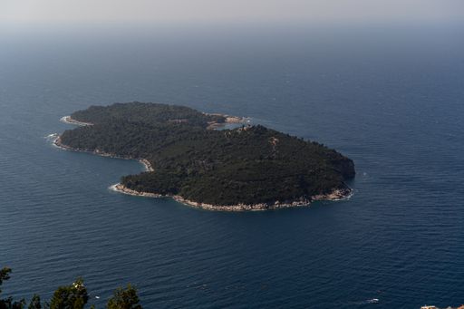 A high angle shot of an island in the sea near Dubrovnik, Croatia with the sea in the background