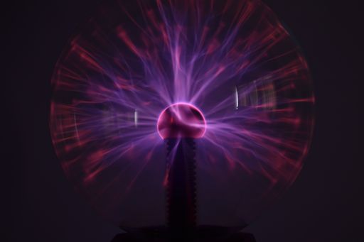 A closeup shot of a colorful plasma ball on a black background