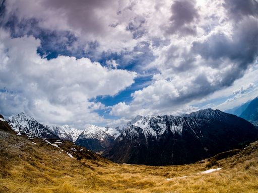 A beautiful shot of mountains covered in snow under a cloudy sky