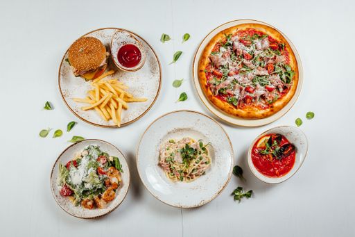 A top view of the various delicious and tasty fresh food on a wooden white surface