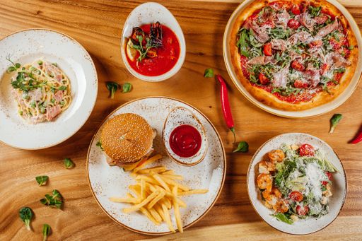 A top view of the various delicious and tasty fresh food on a wooden surface