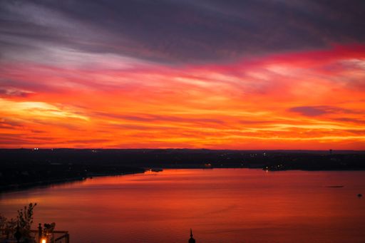 A beautiful shot of a lake with an amazing breathtaking red cloudy sky during sunset