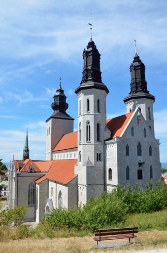 A picturesque view of Visby, Gotland, Sweden with a crystal clear blue sky and a classic church in the background