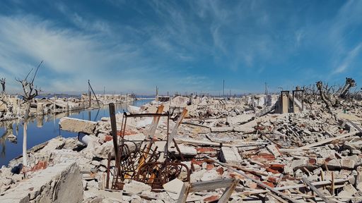 A closeup of the ruins of a town destroyed by water on a sunny day