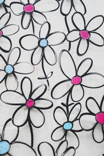 A vertical shot of colorful flower drawings with black outlines against a gray background