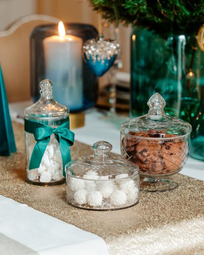 A vertical shot of sweets candle and a vase on a Christmas table